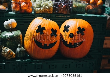 Smiling fresh orange pumpkins on street market. Halloween pumpkin head jack. Halloween pumpkin smile and scary eyes