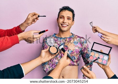 Handsome man wearing make up with make up cosmetics around smiling cheerful pointing with hand and finger up to the side 