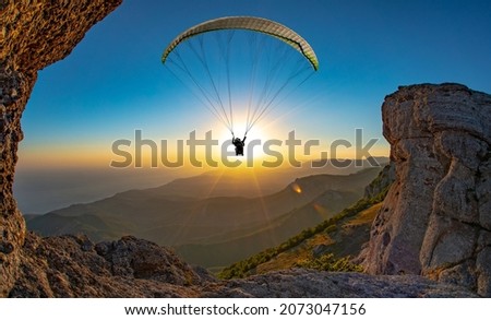 Paragliding concept, paraglider pilot fly in sky on beauty nature mountain landscape Crimea background, horizontal photo Royalty-Free Stock Photo #2073047156