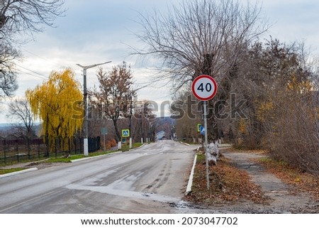A road sign with a speed limit of up to 40 kilometers per hour. Forbidding road sign, by the road, regulating the movement of cars.