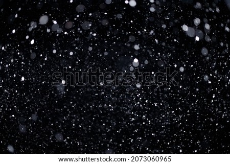 Real falling snow on black background for blending modes in ps. Ver 05 - many snowflakes in blur.