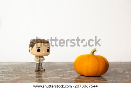 Geek figurine character with tiny real pumpkin