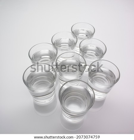 Glasses full of water on grey background