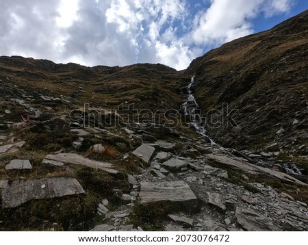 waterfall with a cloudy sky in the natural reserve of Ristolas next to the col agnel
