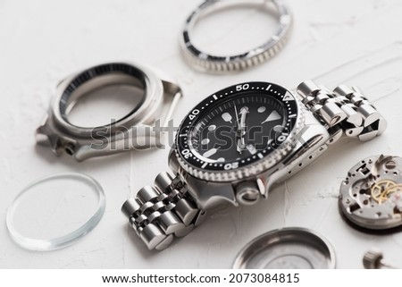 Luxury men wrist watch with watch parts over white background. Repairing wrist watch concept.