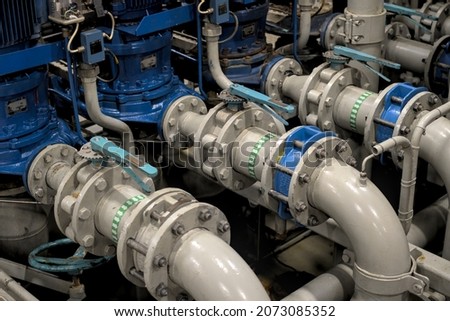 Industrial valves, pipes in modern offshore ship's engine room Royalty-Free Stock Photo #2073085352