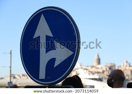 selective focus, straight going and right turn free sign