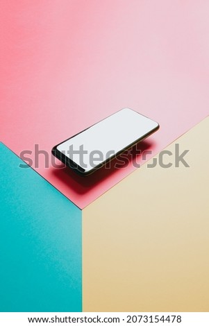 Minimalistic mobile phone blank screen with copy space, floating phone, colorful background with copy space, technology minimal, flat mock up image, social network ad banner type image, primary colors