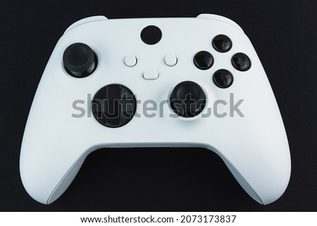 Next generation white game controller isolated on black background.