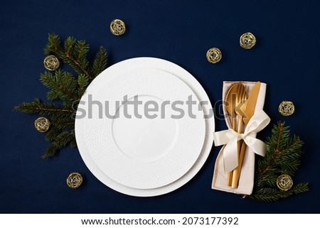 Festive christmas, wedding, birthday table setting with golden cutlery and porcelain plate. Mockup for place card, restaurant menu template. Copy space