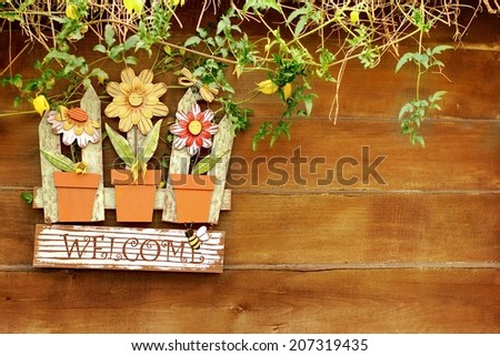 Welcome  signboard on wooden fence in garden. Background with space for text or image.