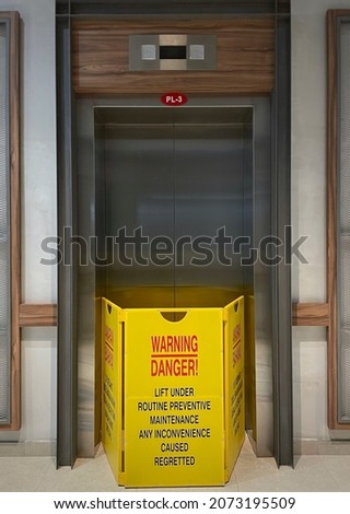 View of elevator or lift closed for repair or routine maintenance. Yellow signage to block any usage. Safety first concept.