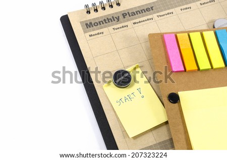 Brown Monthly planner with  notedbook isolated on white background