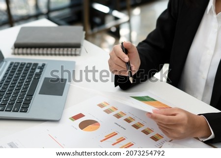 Businesswoman hands hold documents with financial statistic stock photo,discussion and analysis data the charts and graphs. Finance concept