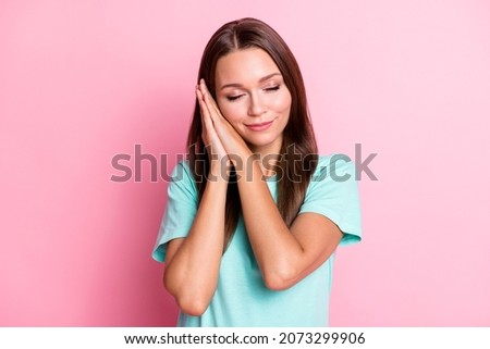 Photo portrait of relaxing sleeping pretty girl keeping hands together snoozing isolated on pastel pink color background