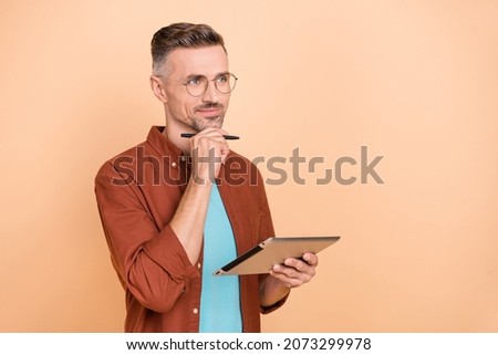 Photo of minded marketer guy use device write stylus think thoughts start-up strategy isolated over pastel beige color background Royalty-Free Stock Photo #2073299978