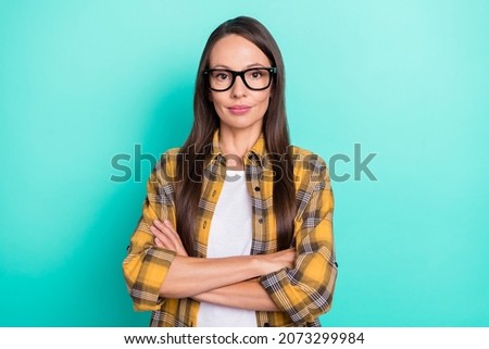 Photo of teacher mature brunette lady crossed arms wear spectacles yellow shirt isolated on turquoise color background