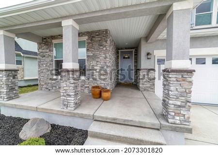 House exterior with stone veneer siding and garage Royalty-Free Stock Photo #2073301820