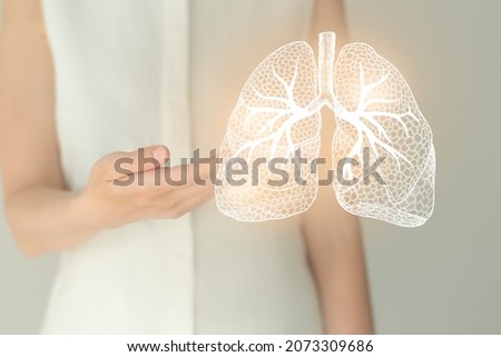 Unrecognizable female patient in white clothes, highlighted handrawn lungs. Human respiratory system issues concept. Royalty-Free Stock Photo #2073309686
