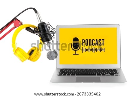 Modern laptop with microphone and headphones on white background