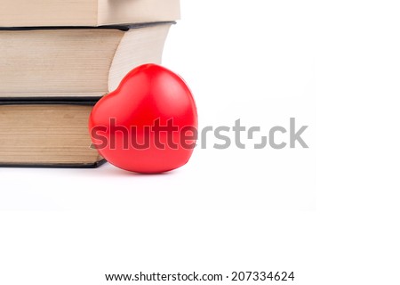 Books with heart on white isolated background