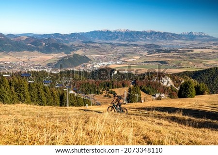 Biker riding MTB from hill hill Malinne in Great Fatra mountains, Slovakia.