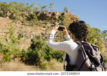 woman taking photos in nature and ancient city