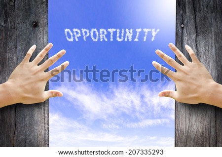 Hand opening the wooden door and see "Opportunity" text cloud in the Sky.