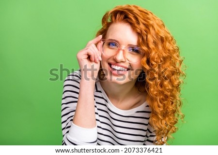 Photo of pretty charming young woman wear striped shirt arm spectacles smiling isolated green color background Royalty-Free Stock Photo #2073376421