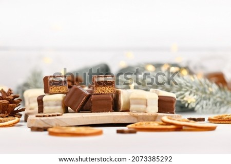 Christmas sweets called 'Dominosteine'. German candy consisting of gingerbread, jelly and marzipan layers covered with chocolate icing 