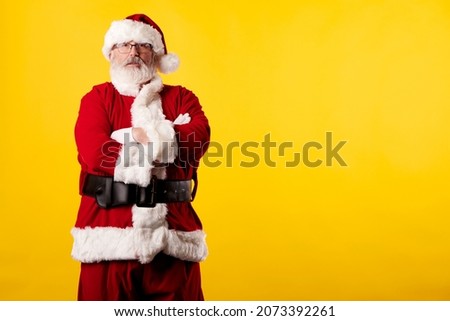 Santa Claus with crossed arms on a yellow background