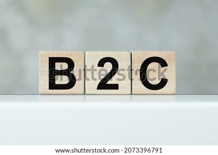 B2C abbreviation - Business to Consumer, on wooden cubes on a light background.