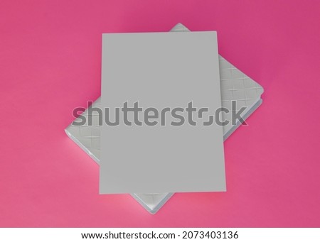 white paper envelope on top of pink background