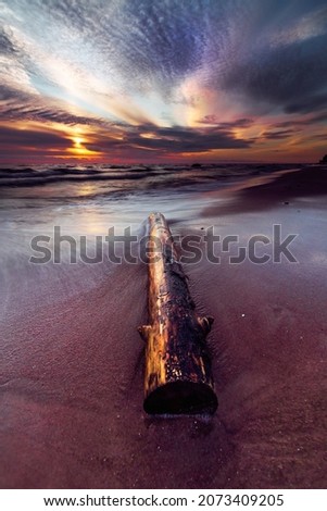A vertical shot of a beautiful sunset with a colorful sky  at the coast of Baltic Sea, Lithuania