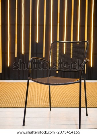 black chair on a background of white lamps on a blurred background