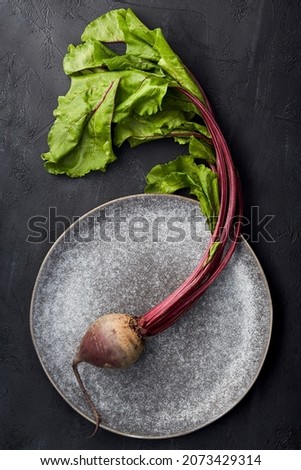 Raw red beetroot on a plate.