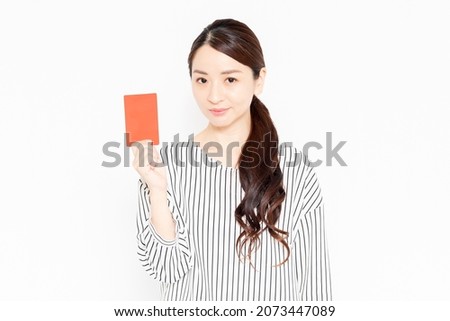 Female in casual clothes showing a red card Royalty-Free Stock Photo #2073447089