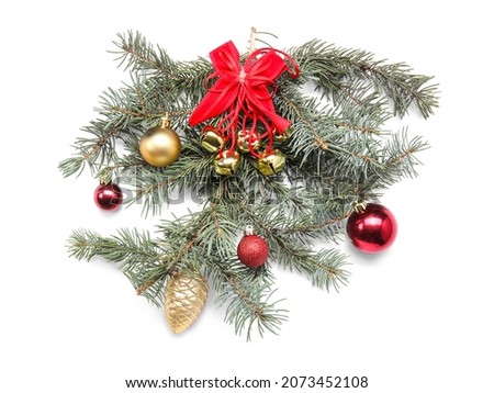 Fir branch with Christmas decorations on white background