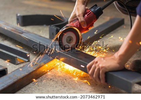 without safety gloves at work. Construction workers do not wear gloves and safety shoes to work. Workplace is not safe. focus on shoes Royalty-Free Stock Photo #2073462971