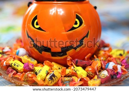 plastic pumpkin and candies for Halloween