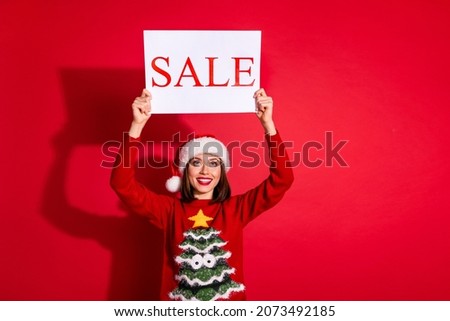 Photo of shiny dreamy young woman wear ornament sweater rising christmas sale poster isolated red color background