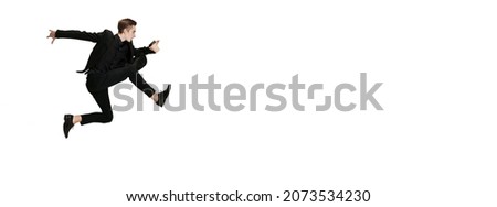 Jumps. Young man in black business suit dancing isolated on white background. Art, motion, action, inspiration and ad concept. Flexible caucasian ballet, contemporary dancer weightless moves. Flyer