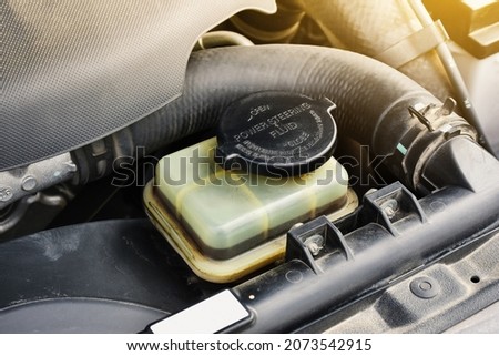 Power steering fluid reservoir of the hydraulic steering wheel in the car Royalty-Free Stock Photo #2073542915