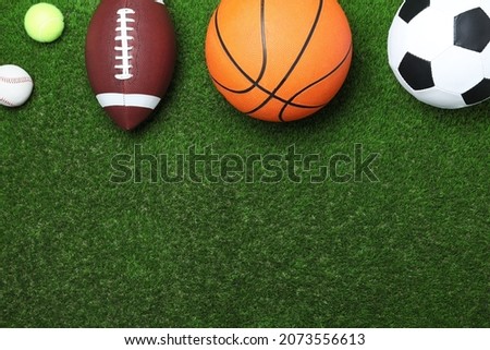 Set of different sport balls on green grass, flat lay. Space for text