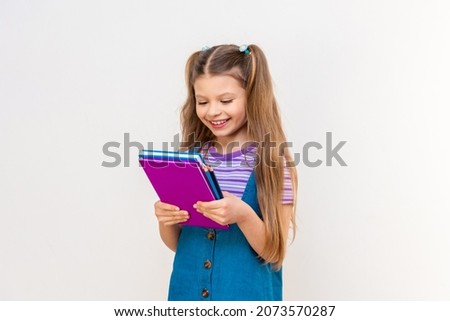 A schoolgirl is reading an interesting book. Reading a book.
