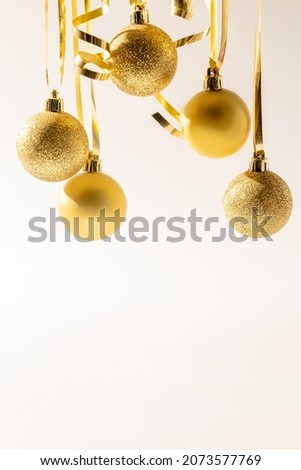 Christmas golden sparkling balls on white background. Christmas concept with copy space.
