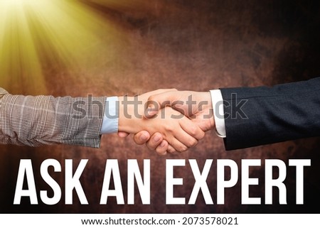 Text caption presenting Ask An Expert. Conceptual photo confirmation that have read understand and agree with guidelines Two Professional Well-Dressed Corporate Businessmen Handshake Indoors