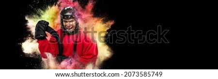Creative collage of young woman, professional hockey player isolated over colorful powder explosion on black background. Concept of art, sport, motivation, action. Copy space for ad