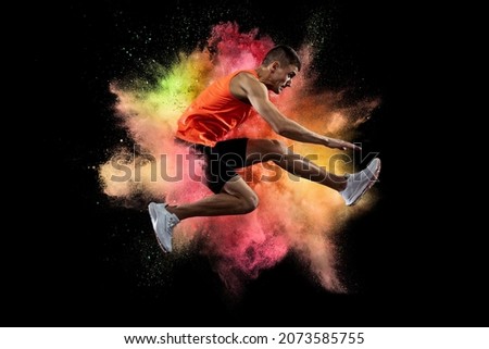 Speed. Creative collage of young man, professional athlete, runner training isolated over colorful powder explosion on black background. Concept of art, sport, motivation, action. Copy space for ad