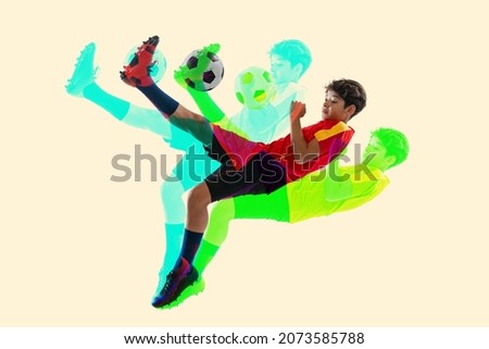 Kicking ball. Creative collage of little boy, teenager, football player training isolated over white background. Glitch and duotine effect. Concept of art, sport, motivation, action. Copy space for ad